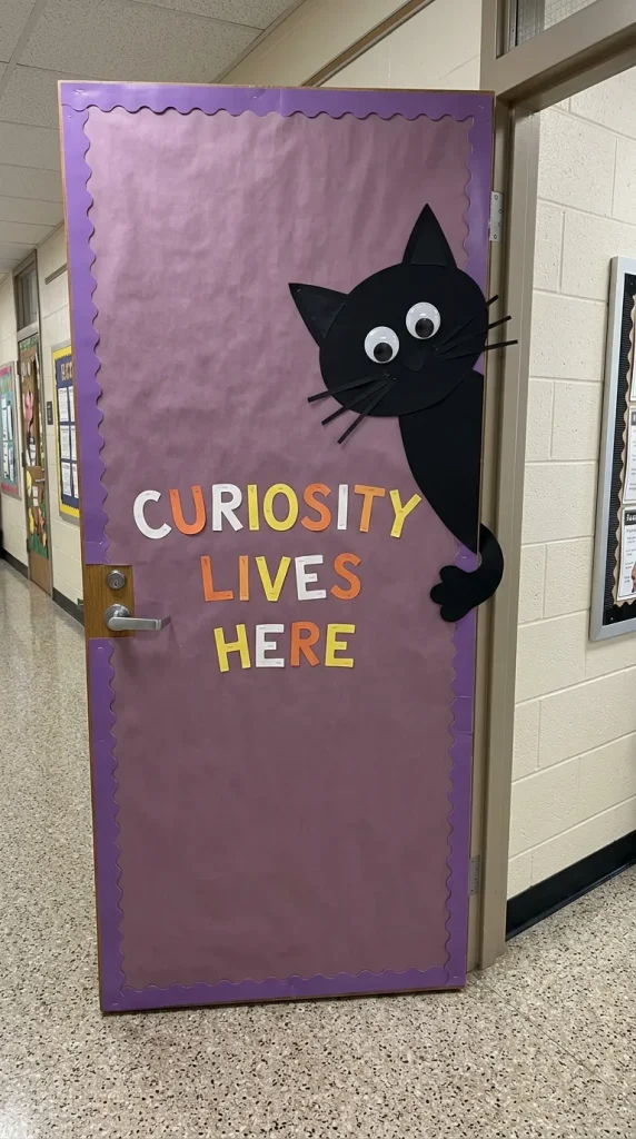 16. Black Cat Peeking Through the Door